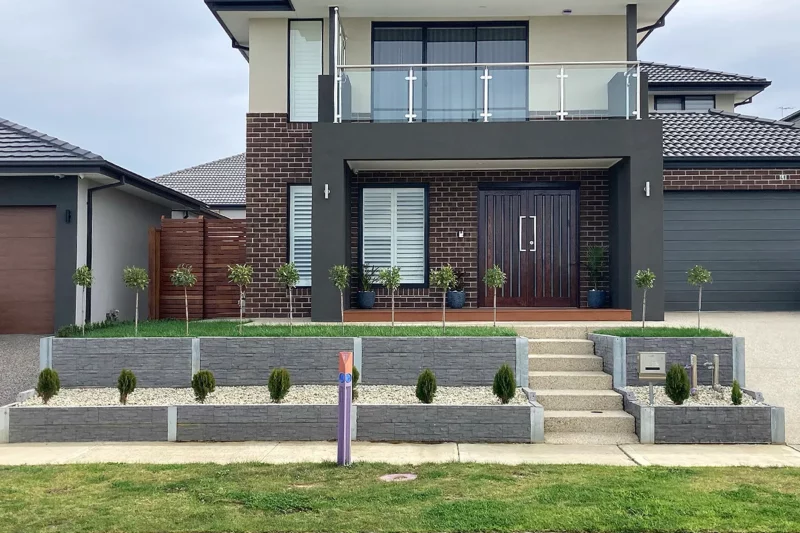Sunset Sleepers The Manhattan Stacked Stone Concrete Sleepers in Charcoal Colour Installed on Small Retaining Wall on a Beautiful Homes Facade in Clyde North VIC