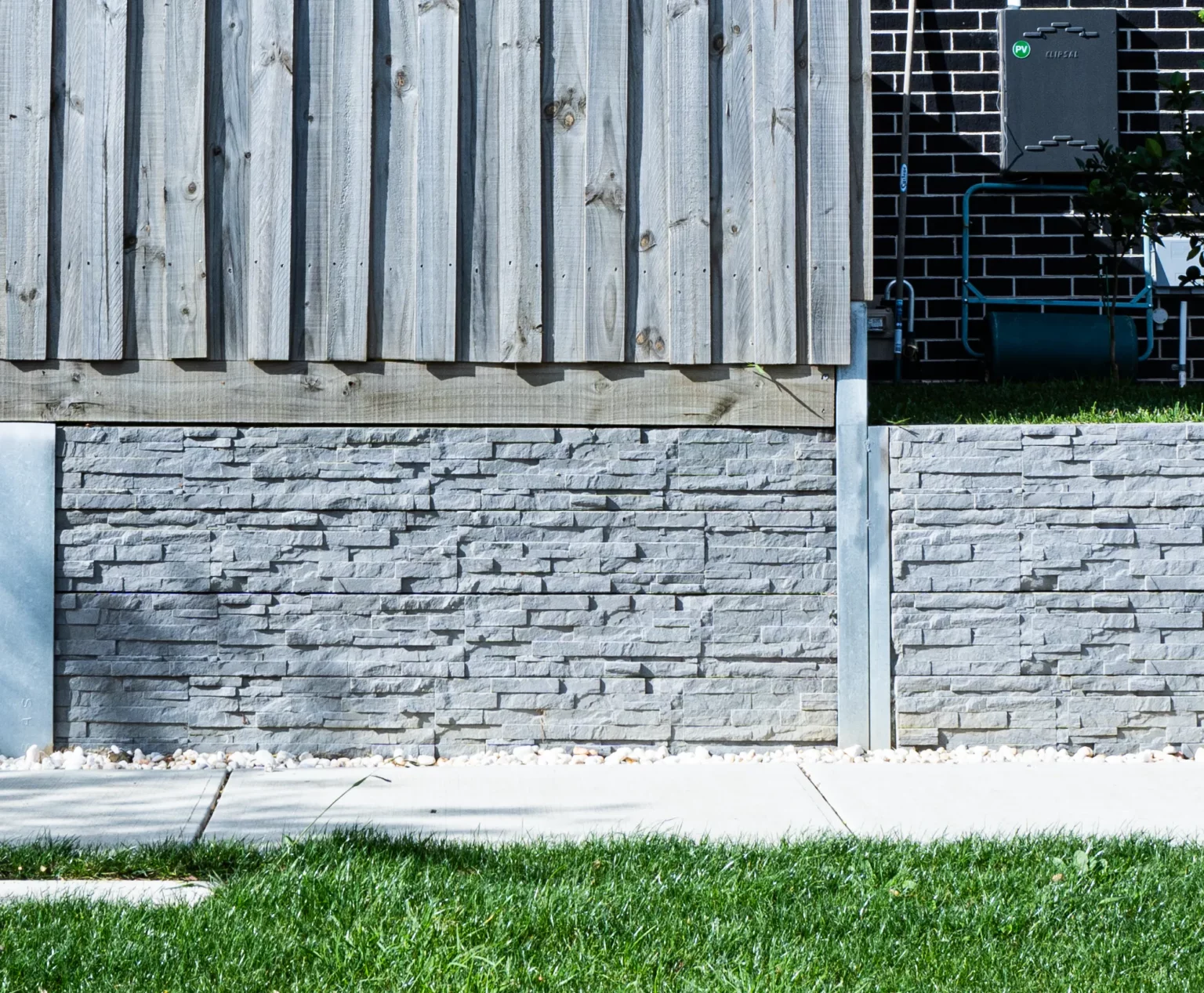 Charcoal Stackedstone Concrete Sleepers Used as Under Fence Plinth for Timber Fence Project across Melbourne and Victoria by Sunset Sleepers