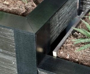 Completed Retaining Wall Project With Charcoal Plastic Capping