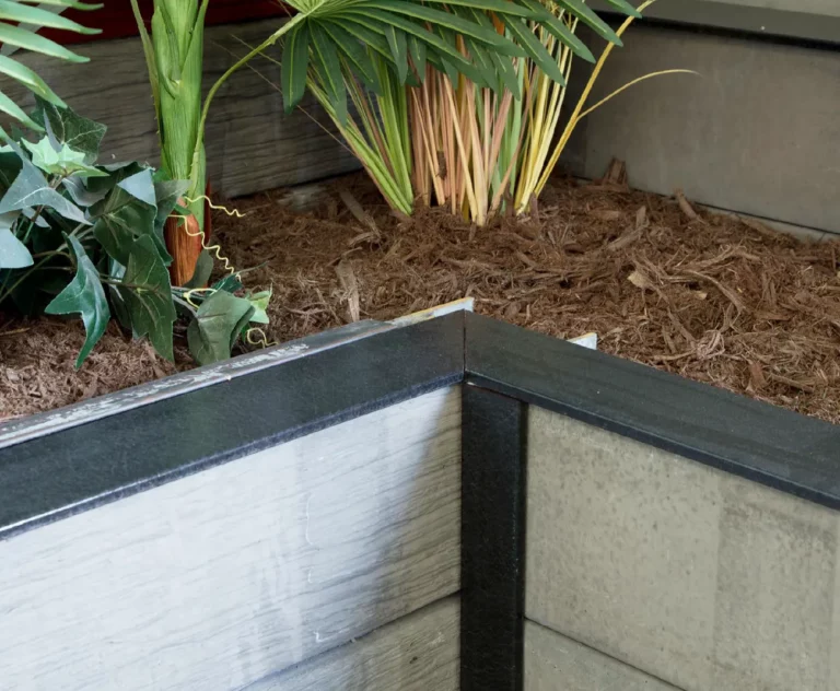 Corner Retaining Wall Project With Charcoal Plastic Capping