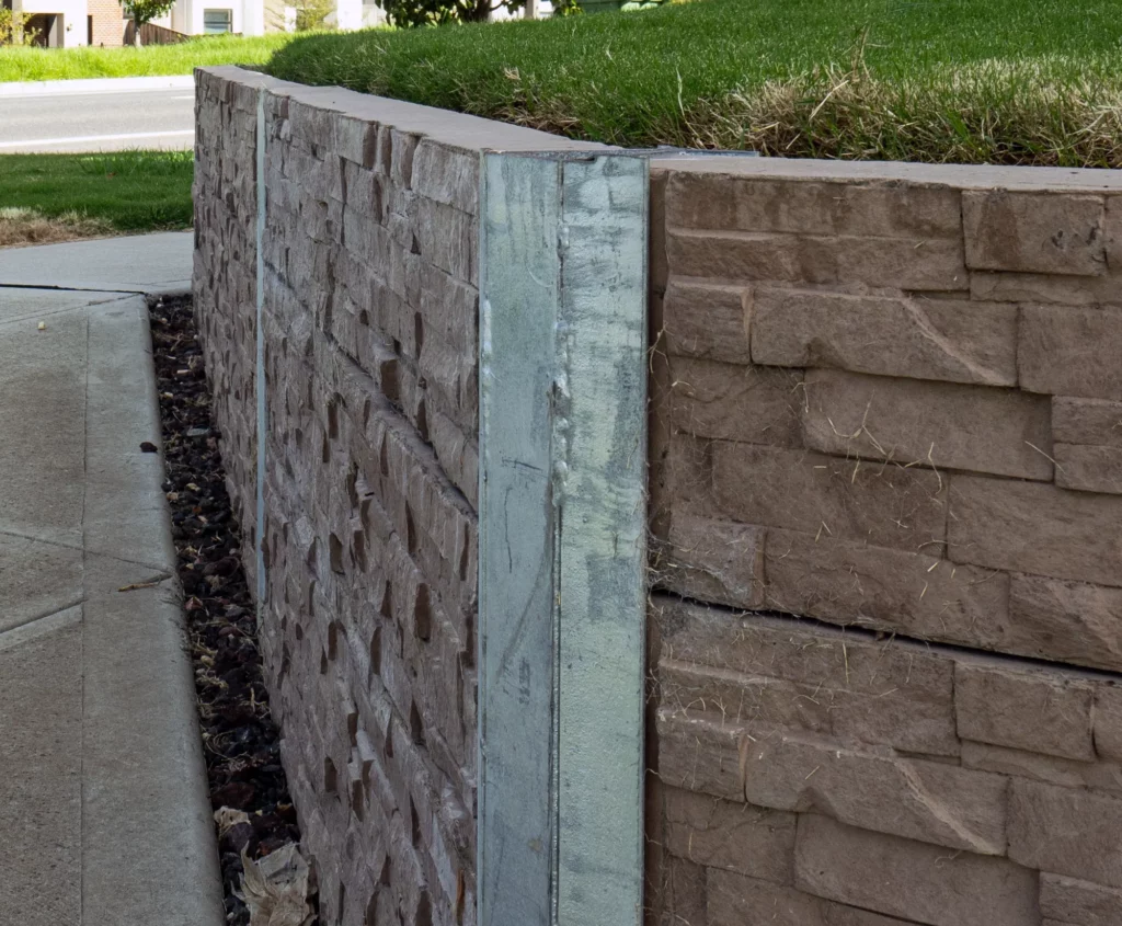 45 Degree Galvanised Steel Angle Posts featuring Jasper Brown Manhattan Stacked Stone Concrete Sleeper by Sunset Sleepers