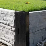 Painted Black 90 Degree Right Angle Corner Galvanised Steel Post featuring Charcoal Manhattan Stacked Stone Concrete Sleeper by Sunset Sleepers.webp
