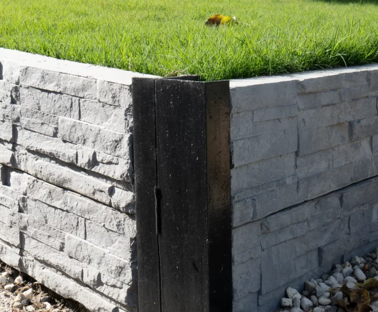 Painted Black 90 Degree Right Angle Corner Galvanised Steel Post featuring Charcoal Manhattan Stacked Stone Concrete Sleeper by Sunset Sleepers.webp