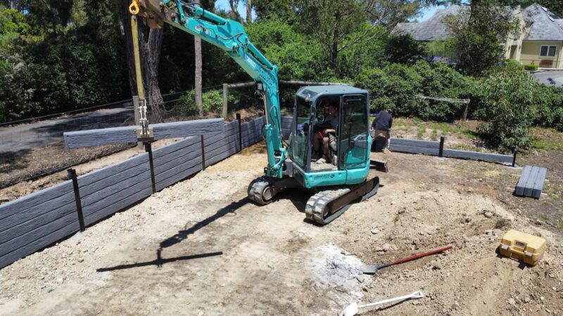 Jamesco Group Building a Retaining Wall in Melbourne using Charcoal Malibu Charcoal Concrete Sleepers Supplied by Sunset Sleepers