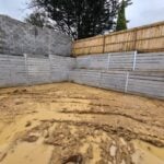 Jamesco Group Constructing a Large Retaining Wall in Melbourne using Plain Grey Marina Smooth Concrete Sleepers Supplied by Sunset Sleepers