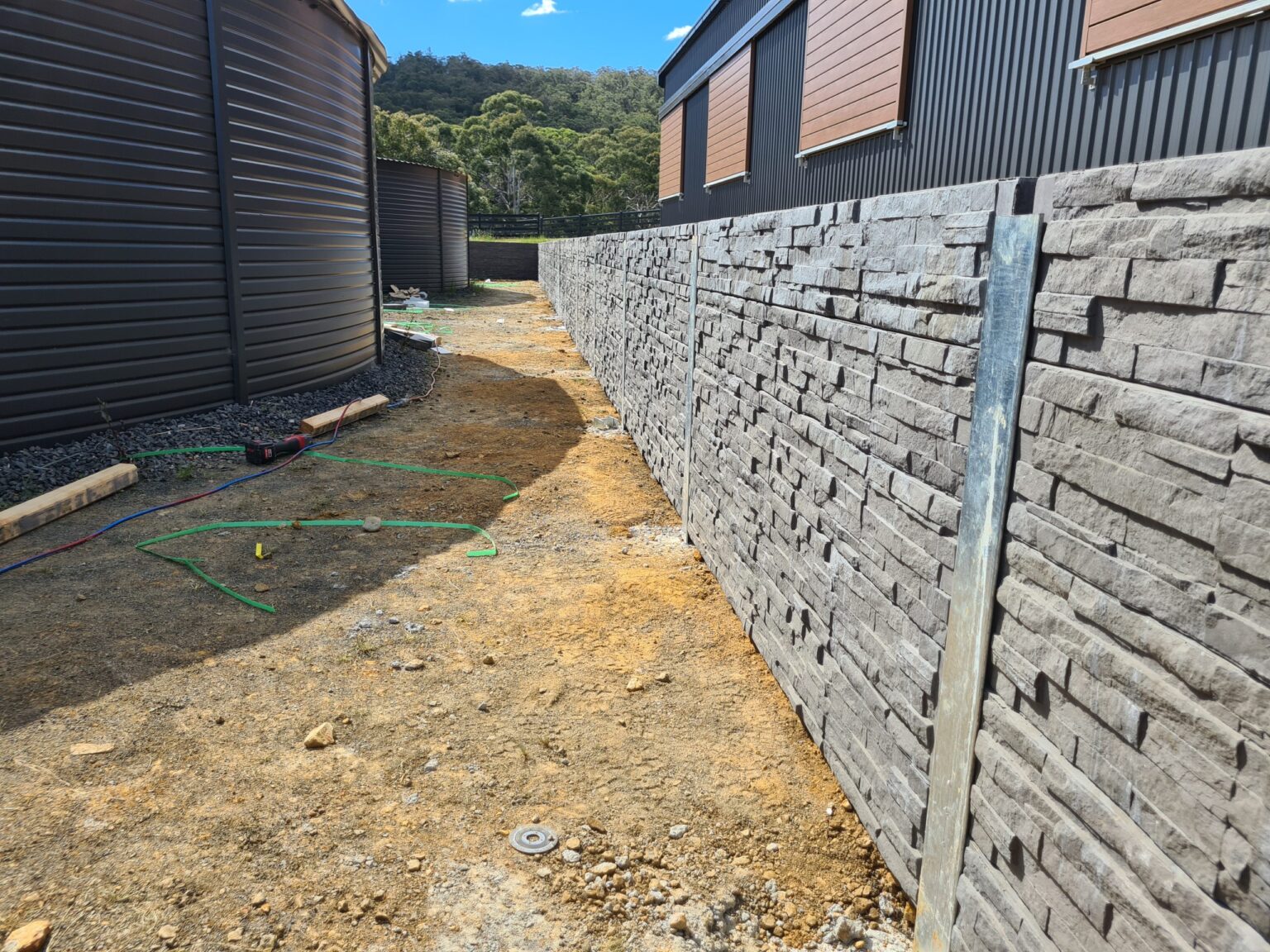 Jamesco Group Newley Built Retaining Wall in Melbourne using Charcoal Manhattan Stackedstone Concrete Sleepers Supplied by Sunset Sleepers
