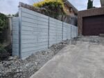 Jamesco Group Newley Built Tall Retaining Wall in Melbourne using Plain Grey Marina Smooth Concrete Sleepers Supplied by Sunset Sleepers