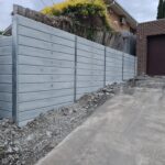 Jamesco Group Newley Built Tall Retaining Wall in Melbourne using Plain Grey Marina Smooth Concrete Sleepers Supplied by Sunset Sleepers