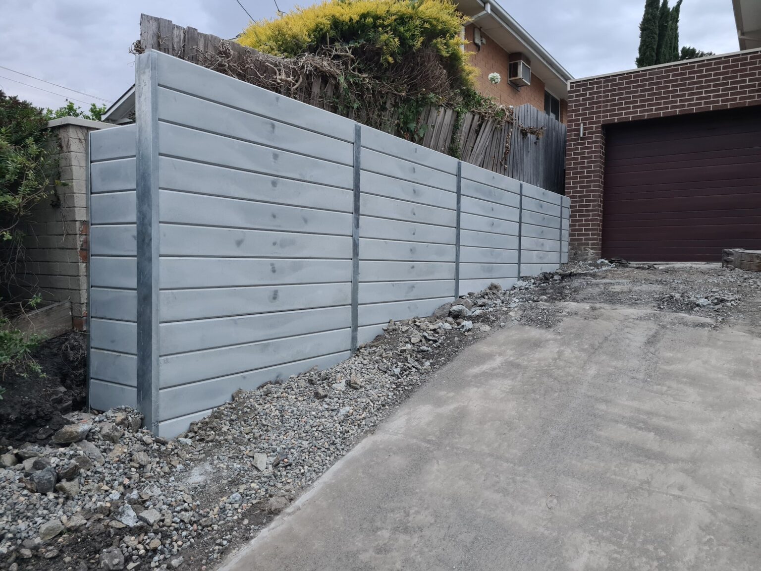Jamesco Group Newley Built Tall Retaining Wall in Melbourne using Plain Grey Marina Smooth Concrete Sleepers Supplied by Sunset Sleepers