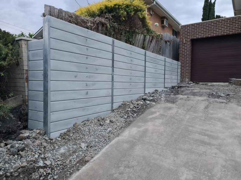 Jamesco Group Newley Built Tall Retaining Wall in Melbourne using Plain Grey Marina Smooth Concrete Sleepers Supplied by Sunset Sleepers