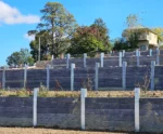 100mm Thick Charcoal Malibu Woodgrain Concrete Sleepers Being Installed on a Large New Estate in Officer and Supplied by Sunset Sleepers