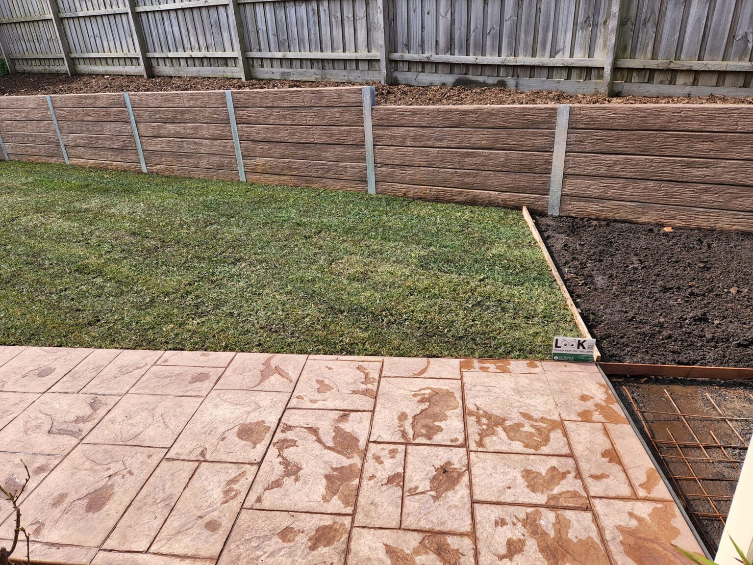 Backyard Boundary Retaining Wall Built by Dream View Landscape Using Jasper Brown Malibu Woodgrain Concrete Sleepers and Supplied by Sunset Sleepers