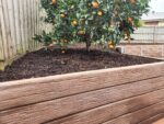 Backyard Garden Bed Retaining Wall Built by Dream View Landscape Using Jasper Brown Malibu Woodgrain Concrete Sleepers and Supplied by Sunset Sleepers