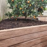 Backyard Garden Bed Retaining Wall Built by Dream View Landscape Using Jasper Brown Malibu Woodgrain Concrete Sleepers and Supplied by Sunset Sleepers