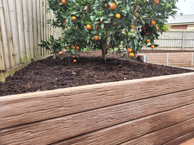 Backyard Garden Bed Retaining Wall Built by Dream View Landscape Using Jasper Brown Malibu Woodgrain Concrete Sleepers and Supplied by Sunset Sleepers