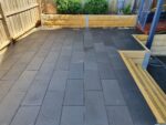 Backyard Paving and Feature Retaining Wall Using Sandstone Yellow Arizona Block Face Concrete Sleepers Constructed by Dream View Landscape and Supplied by Sunset Sleepers