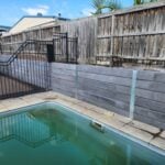 Backyard Pool Area Retaining Wall Built by Dream View Landscape Using Charcoal Marina Smooth Concrete Sleepers and Supplied by Sunset Sleepers