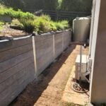 Backyard Retaining Wall Under Construction by Dream View Landscape Using Charcoal Malibu Woodgrain Concrete Sleepers and Supplied by Sunset Sleepers