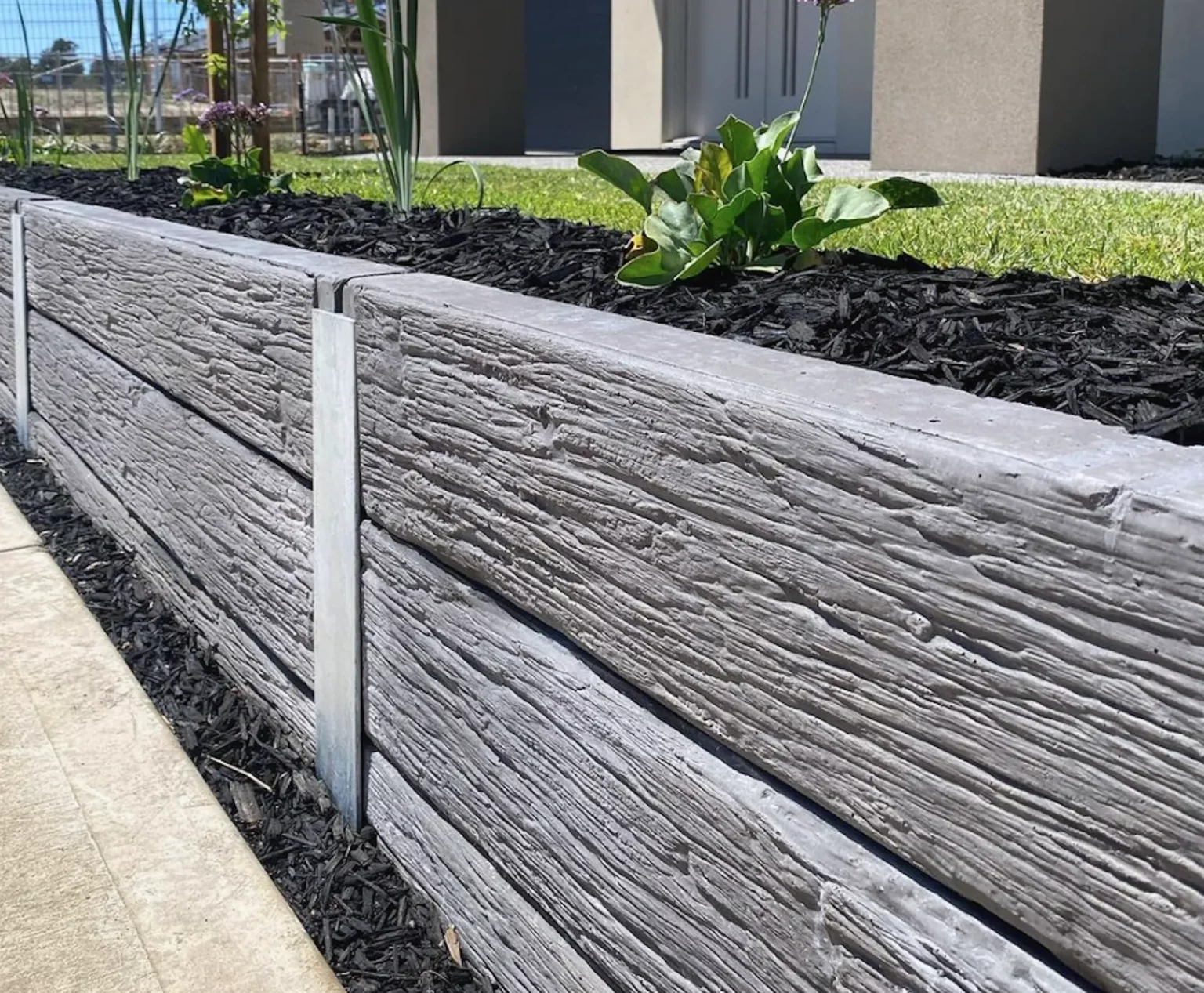 Charcoal Malibu Woodgrain Concrete Sleepers on Small Front Yard Retaining Wall Supplied by Sunset Sleepers