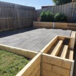 Completed Backyard Feature Retaining Wall Using Sandstone Yellow Arizona Block Face Concrete Sleepers Constructed by Dream View Landscape and Supplied by Sunset Sleepers