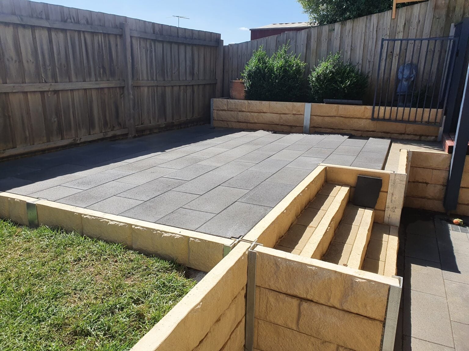 Completed Backyard Feature Retaining Wall Using Sandstone Yellow Arizona Block Face Concrete Sleepers Constructed by Dream View Landscape and Supplied by Sunset Sleepers