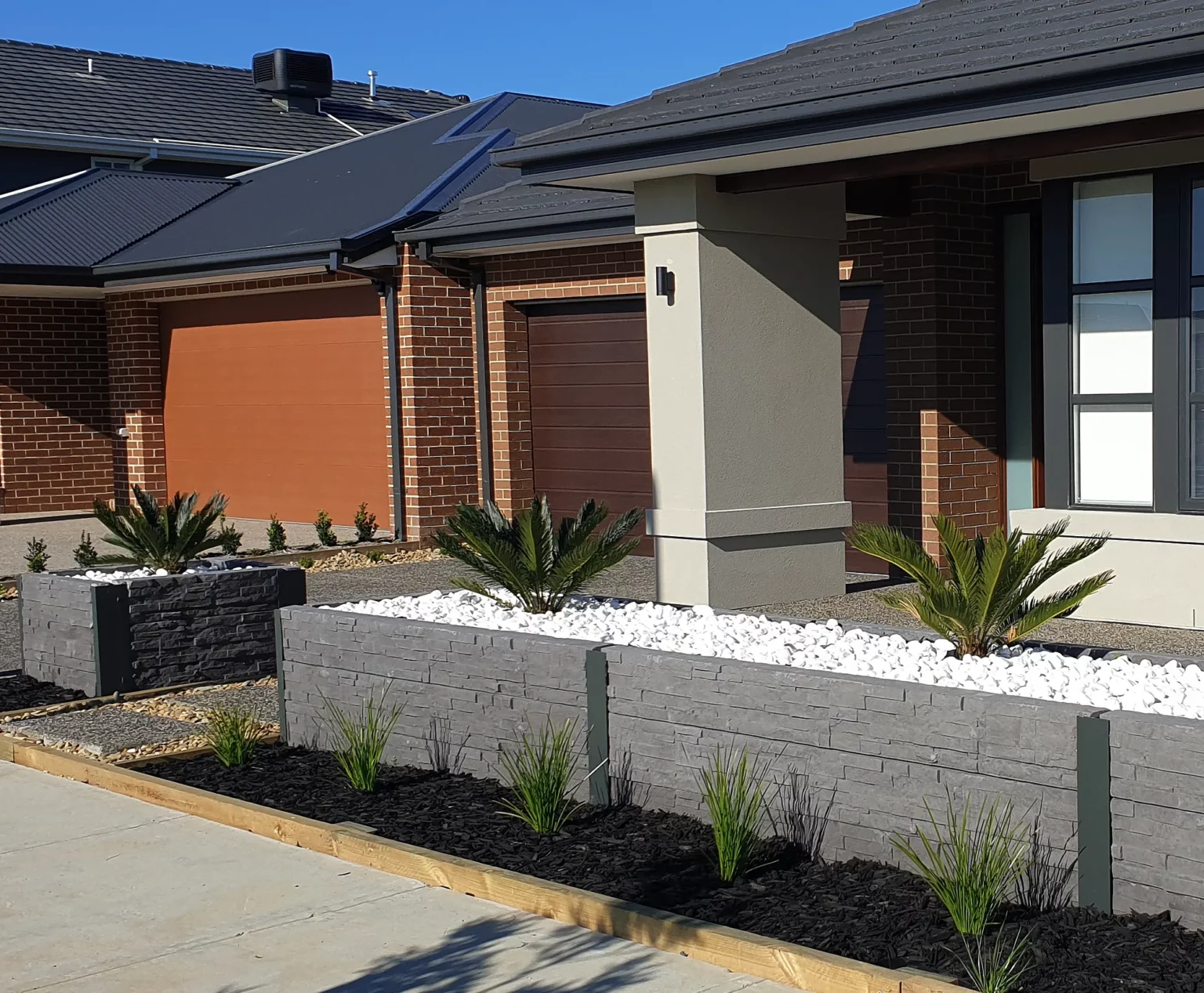 Completed Front Yard Garden Bed Project in Melbourne Using the Charcoal Manhattan Stacked Stone Concrete Sleepers Supplied by Sunset Sleepers