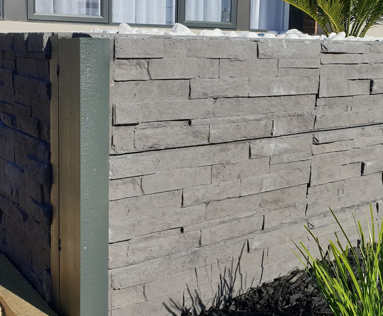 Detailed Close Up of a Small DIY Retaining Wall Project for a Front Yard Garden Bed in Melbourne Using the Charcoal Manhattan Stacked Stone Concrete Sleepers