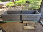 Garden Bed Retaining Wall Under Construction by Dream View Landscape Using Charcoal Manhattan Stacked Stone Concrete Sleepers and Supplied by Sunset Sleepers