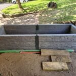 Garden Bed Retaining Wall Under Construction by Dream View Landscape Using Charcoal Manhattan Stacked Stone Concrete Sleepers and Supplied by Sunset Sleepers