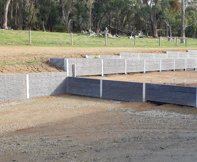 Large Rural Retaining Wall Project in Progress in Melbourne Using the Charcoal Manhattan Stacked Stone Concrete Sleepers Supplied by Sunset Sleepers