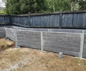 Gallery 1 Malibu Woodgrain Concrete Sleepers in Charcoal Used for a Garden Bed Retaining Wall Project and Supplied by Sunset Sleepers