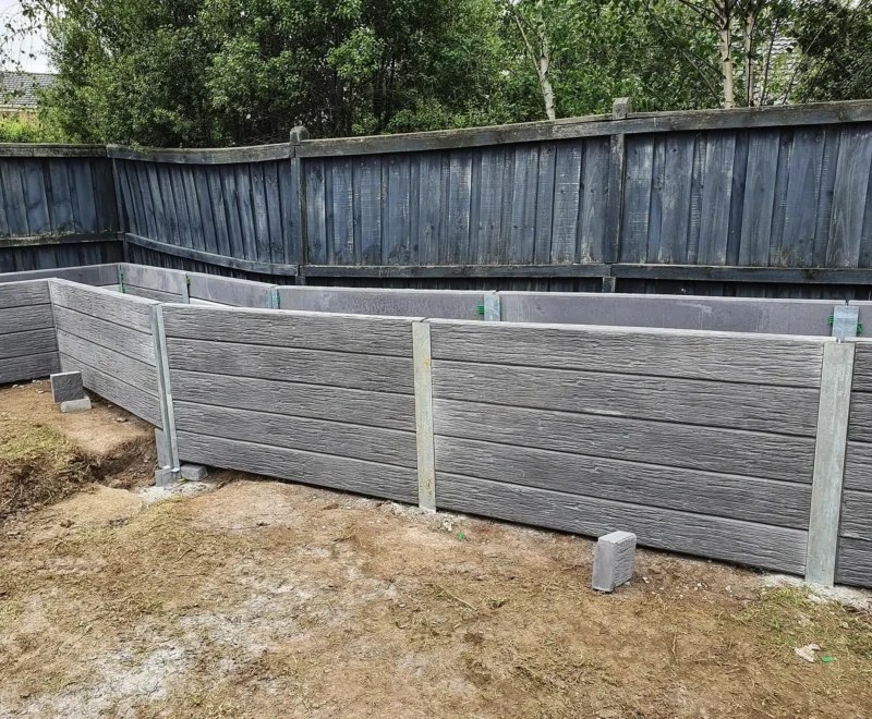 Malibu Woodgrain Concrete Sleepers in Charcoal Used for a Garden Bed Retaining Wall Project and Supplied by Sunset Sleepers