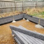 New Small Retaining Wall Under Construction by Dream View Landscape Using Charcoal Arizona Block face Concrete Sleepers and Supplied by Sunset Sleepers