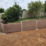 Newly Built Backyard Retaining Wall by Dream View Landscape Using Jasper Brown Malibu Woodgrain Concrete Sleepers and Supplied by Sunset Sleepers