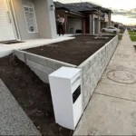 Newly Built Retaining Wall in Front Yard for a New Home Using the Ash Arizona Block Face Concrete Sleepers Built by Ferguson Landscape & Design and Supplied by Sunset Sleepers