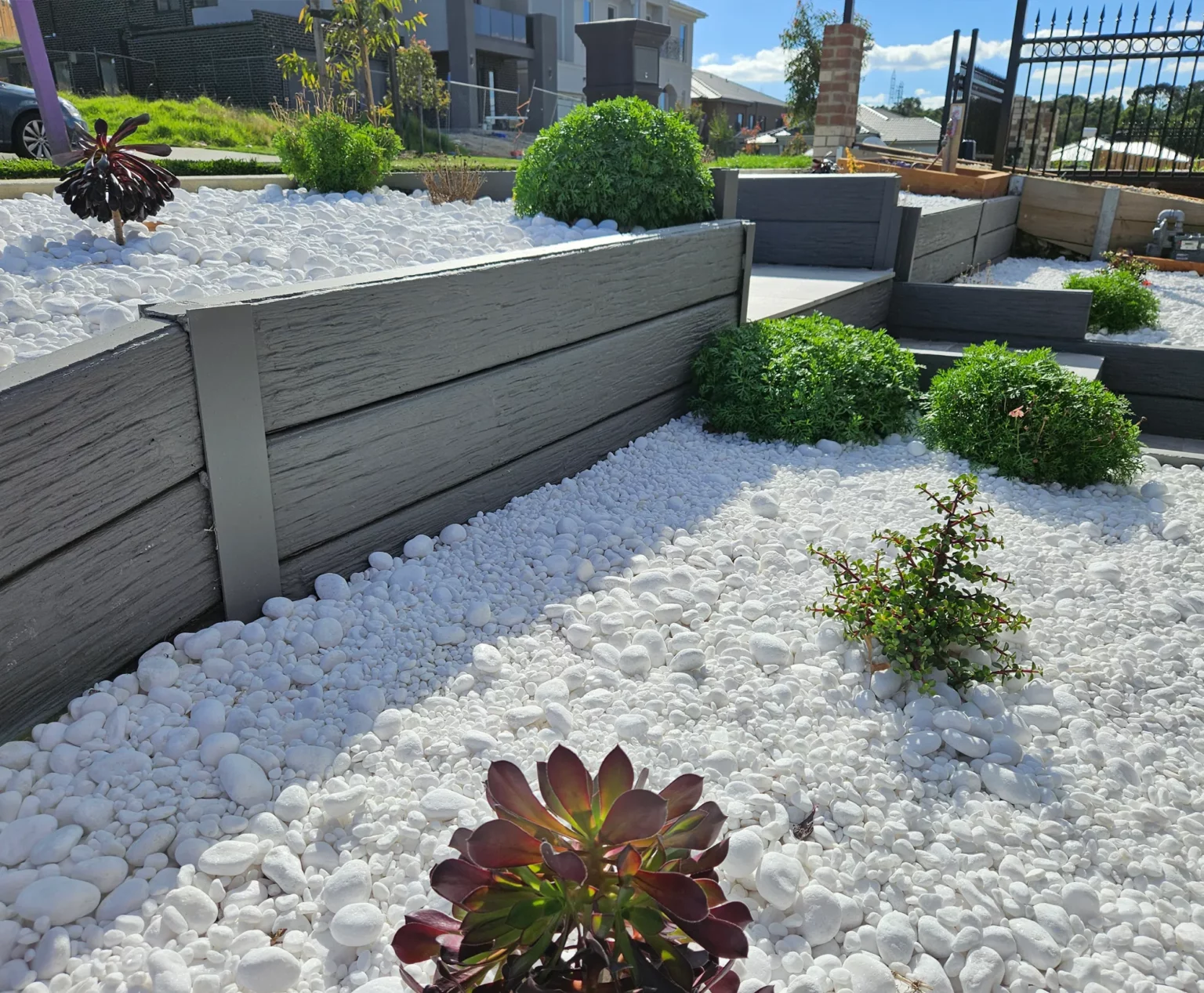 Painted Malibu Woodgrain Concrete Sleepers On a small Garden Retaining Wall Project and Supplied by Sunset Sleepers