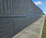 Plain Smooth Concrete Sleepers in The Marina Range used in an Under Timber Fence Retaining Wall Project and Painted On and Supplied by Sunset Sleepers