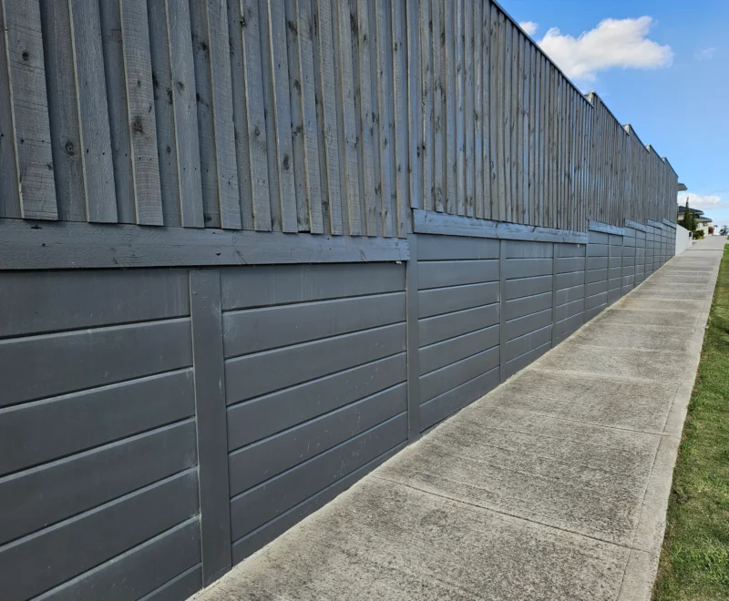 Plain Smooth Concrete Sleepers in The Marina Range used in an Under Timber Fence Retaining Wall Project and Painted On and Supplied by Sunset Sleepers
