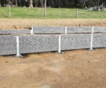 Rural Retaining Wall Project in Progress using The Charcoal Manhattan Stacked Stone Concrete Sleepers Supplied by Sunset Sleepers