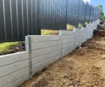 Side of House Retaining Wall Constructed Project Using The Marina Smooth Concrete Sleepers in Plain Grey and Supplied by Sunset Sleepers