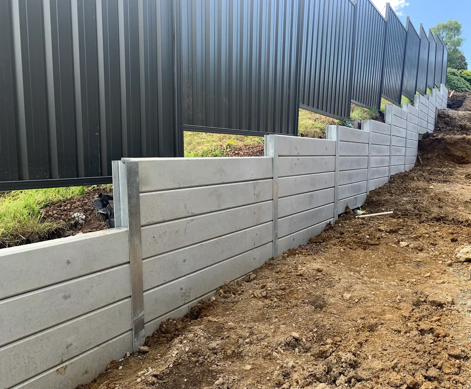 Side of House Retaining Wall Constructed Project Using The Marina Smooth Concrete Sleepers in Plain Grey and Supplied by Sunset Sleepers