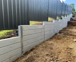Gallery 11 Side of House Retaining Wall Constructed Project Using The Marina Smooth Concrete Sleepers in Plain Grey and Supplied by Sunset Sleepers