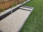 Small Fire Pit Area in Backyard Retaining Wall Feature Using Charcoal Manhattan Stacked Stone Concrete Sleepers Built by Dream View Landscape and Supplied by Sunset Sleepers