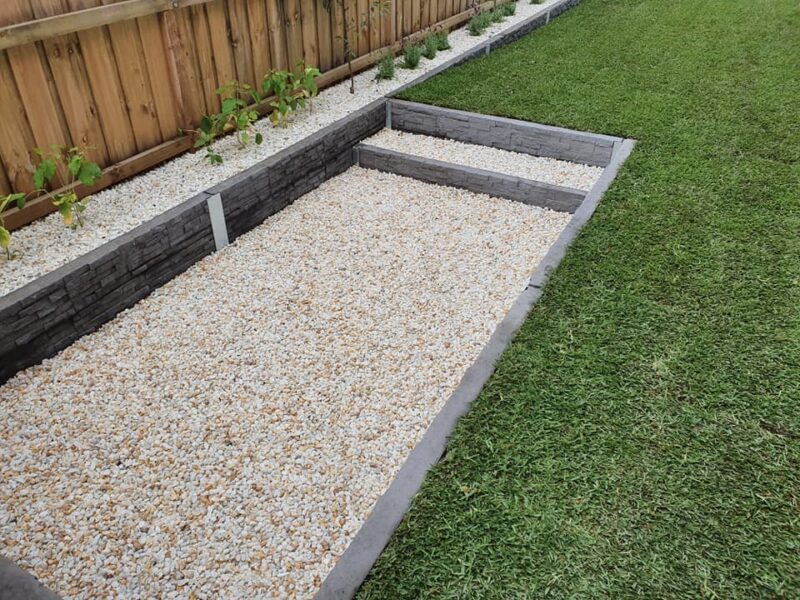 Small Fire Pit Area in Backyard Retaining Wall Feature Using Charcoal Manhattan Stacked Stone Concrete Sleepers Built by Dream View Landscape and Supplied by Sunset Sleepers
