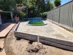Small Retaining Wall Construction Around Pool Area Built Dream View Landscape Using Charcoal Malibu Woodgrain Concrete Sleepers and Supplied by Sunset Sleepers