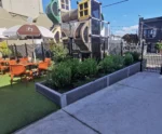 Small Retaining Wall Project in a Commercial Application for Auburn Hotel in Hawthorn East using Charcoal Smooth Concrete Sleepers in The Marina Range and Supplied by Sunset Sleepers