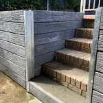 Sunset Sleepers supplied charcoal Malibu woodgrain concrete sleepers which were installed on the stairway walkway in the backyard pool area - Constructed by the team at JBS Retaining Walls & Excavations