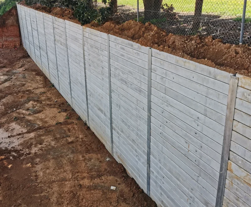 Tall Heavy Duty Retaining Wall Project Using The Plain Grey Marina Smooth Concrete Sleepers and Supplied by Sunset Sleepers