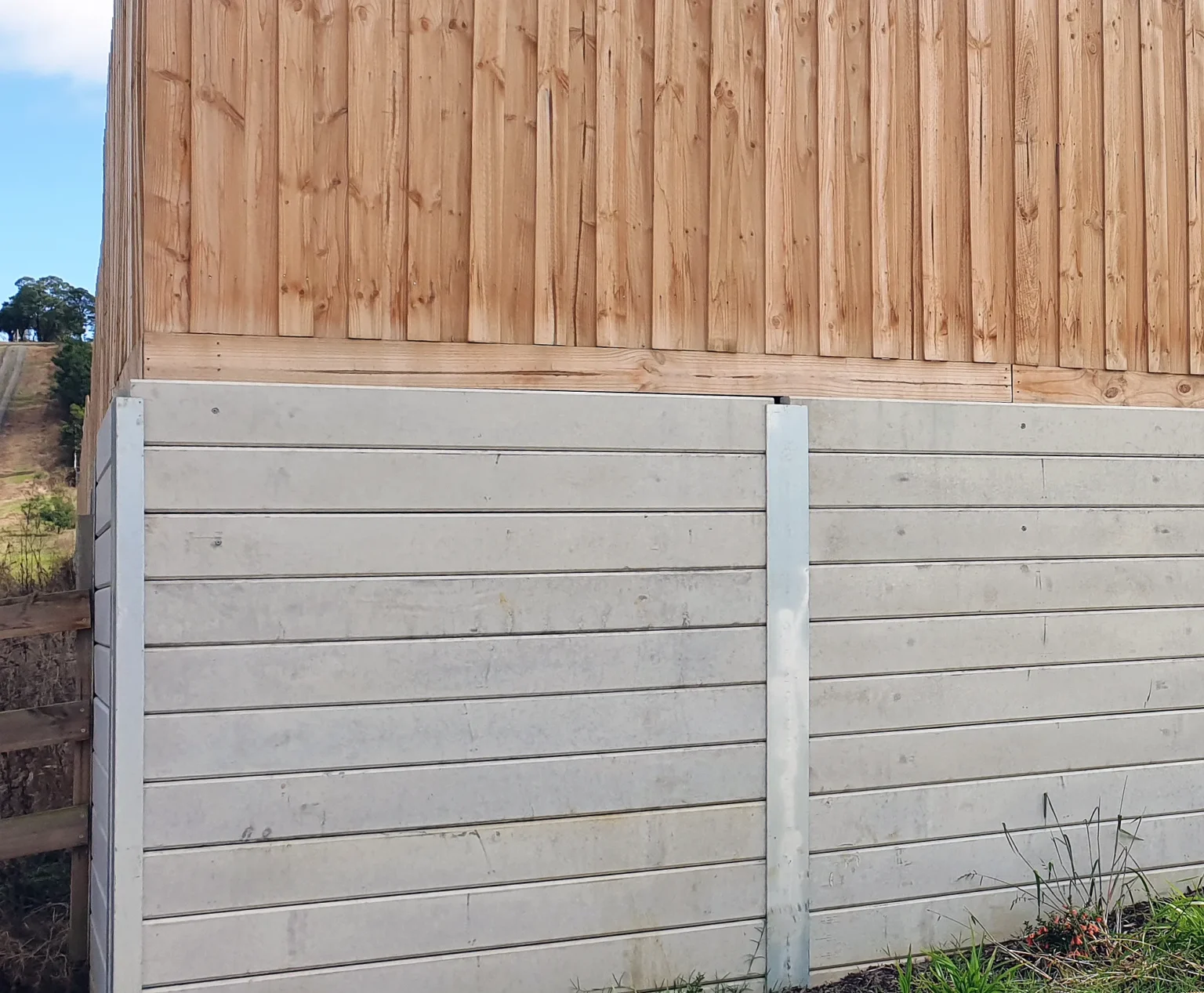 The Marina Smooth Concrete Sleepers in Plain Grey Used For Under Timber Fence Retaining Wall Project and Supplied by Sunset Sleepers