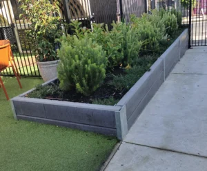 The Marina Smooth Face Concrete Sleeper in Charcoal Used for Small Garden Bed Retaining Wall Project and Supplied by Sunset Sleepers